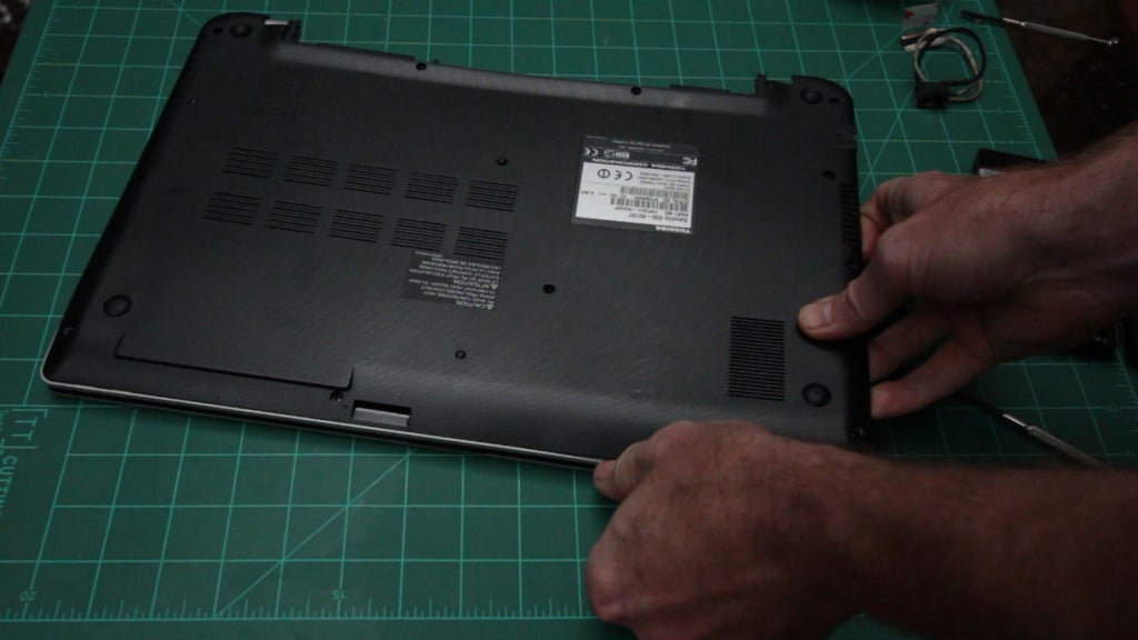 Close the laptop with a screwdriver